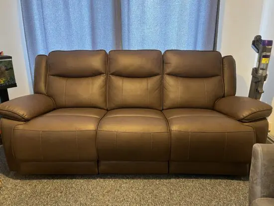 Near new 3 seater manual recliner: brown leather.