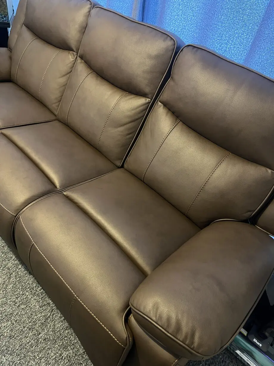 Near new 3 seater manual recliner: brown leather.
