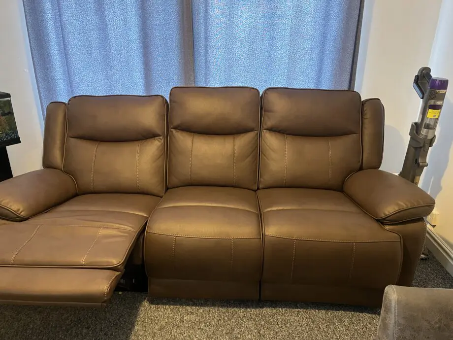 Near new 3 seater manual recliner: brown leather.