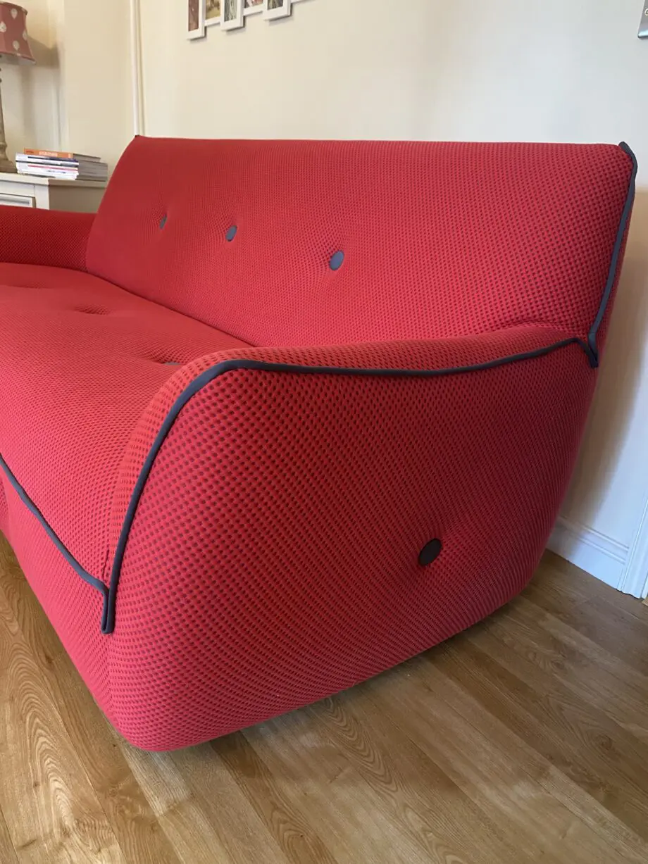Red sofa with grey detail.