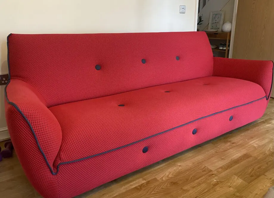 Red sofa with grey detail.