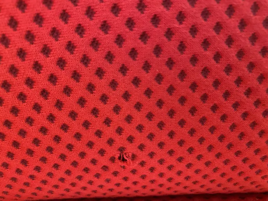 Red sofa with grey detail.