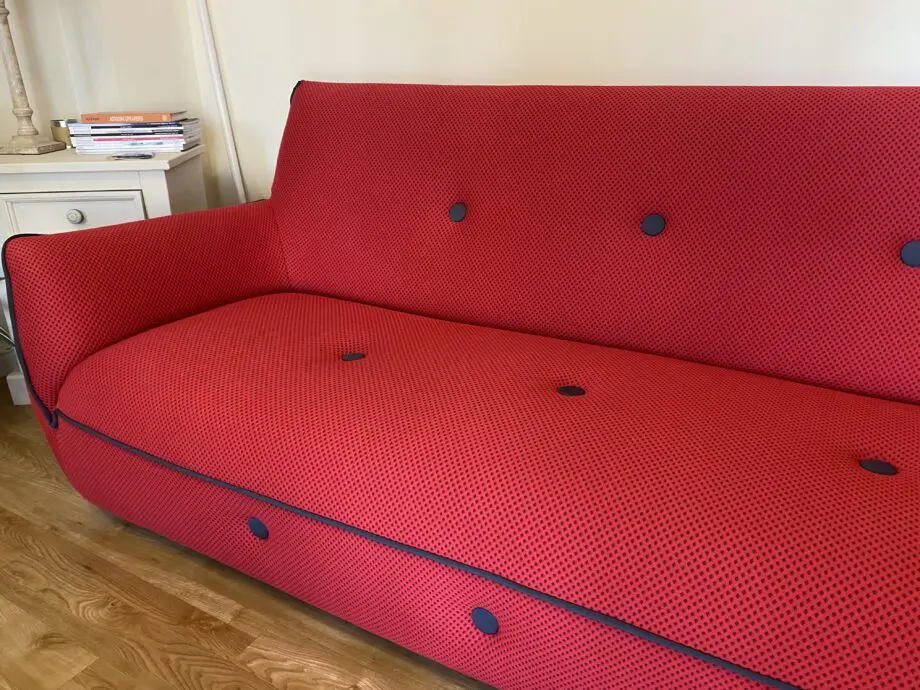 Red sofa with grey detail.