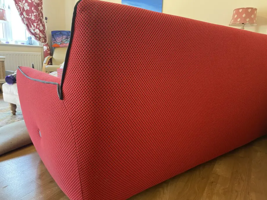 Red sofa with grey detail.