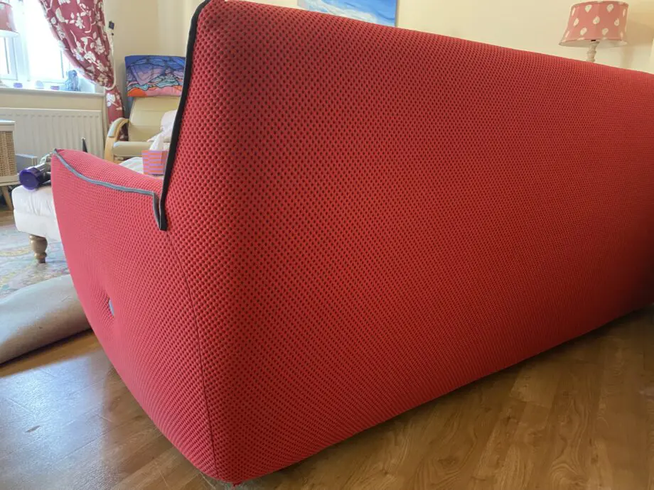 Red sofa with grey detail.