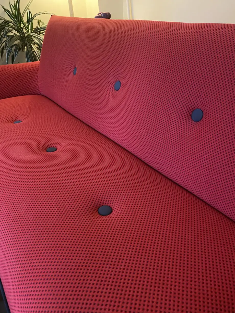 Red sofa with grey detail.