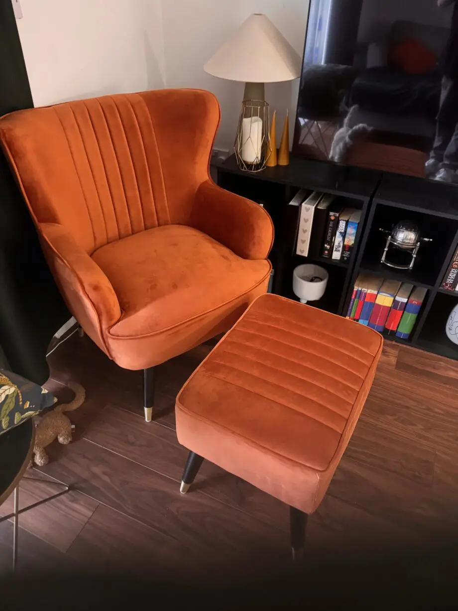 A orange sofa seat with stool