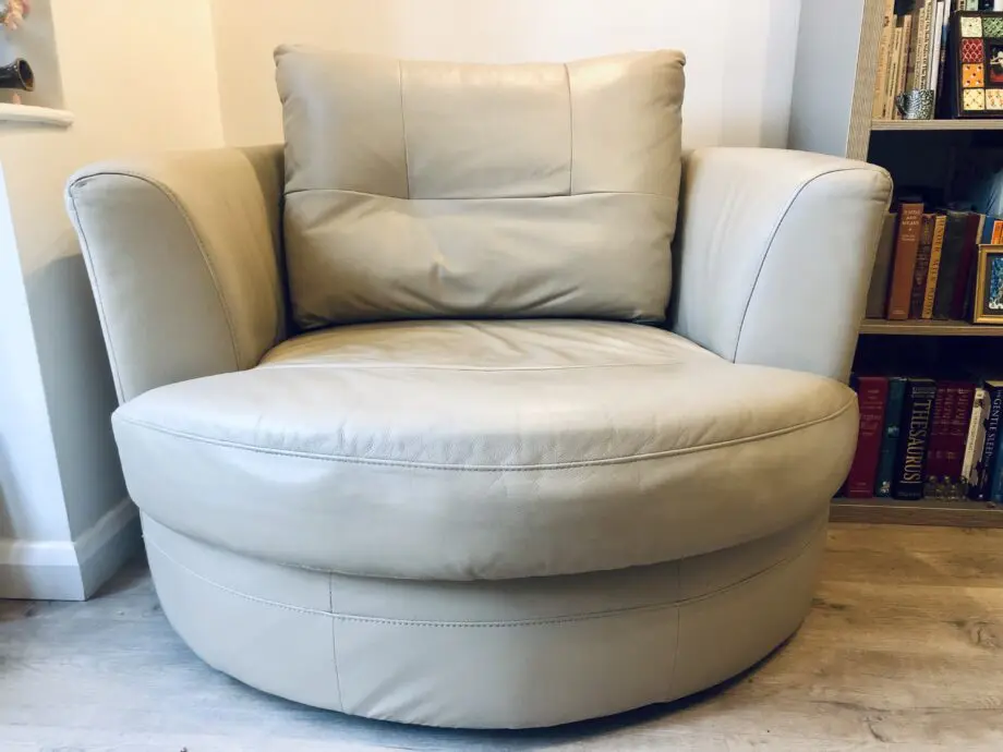 Beige leather swivel cuddle chair love seat round
