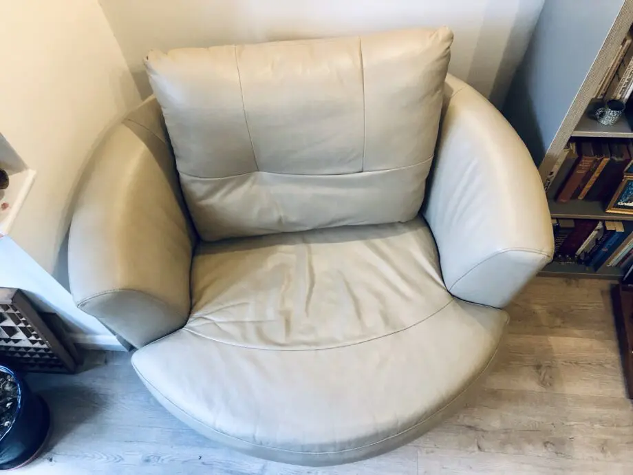 Beige leather swivel cuddle chair love seat round