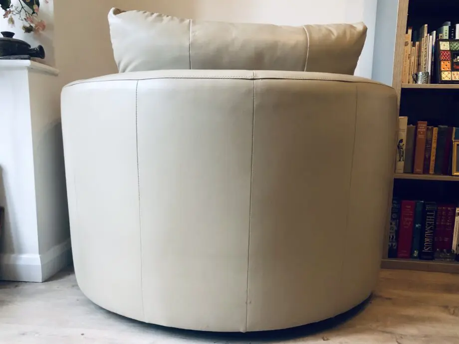 Beige leather swivel cuddle chair love seat round