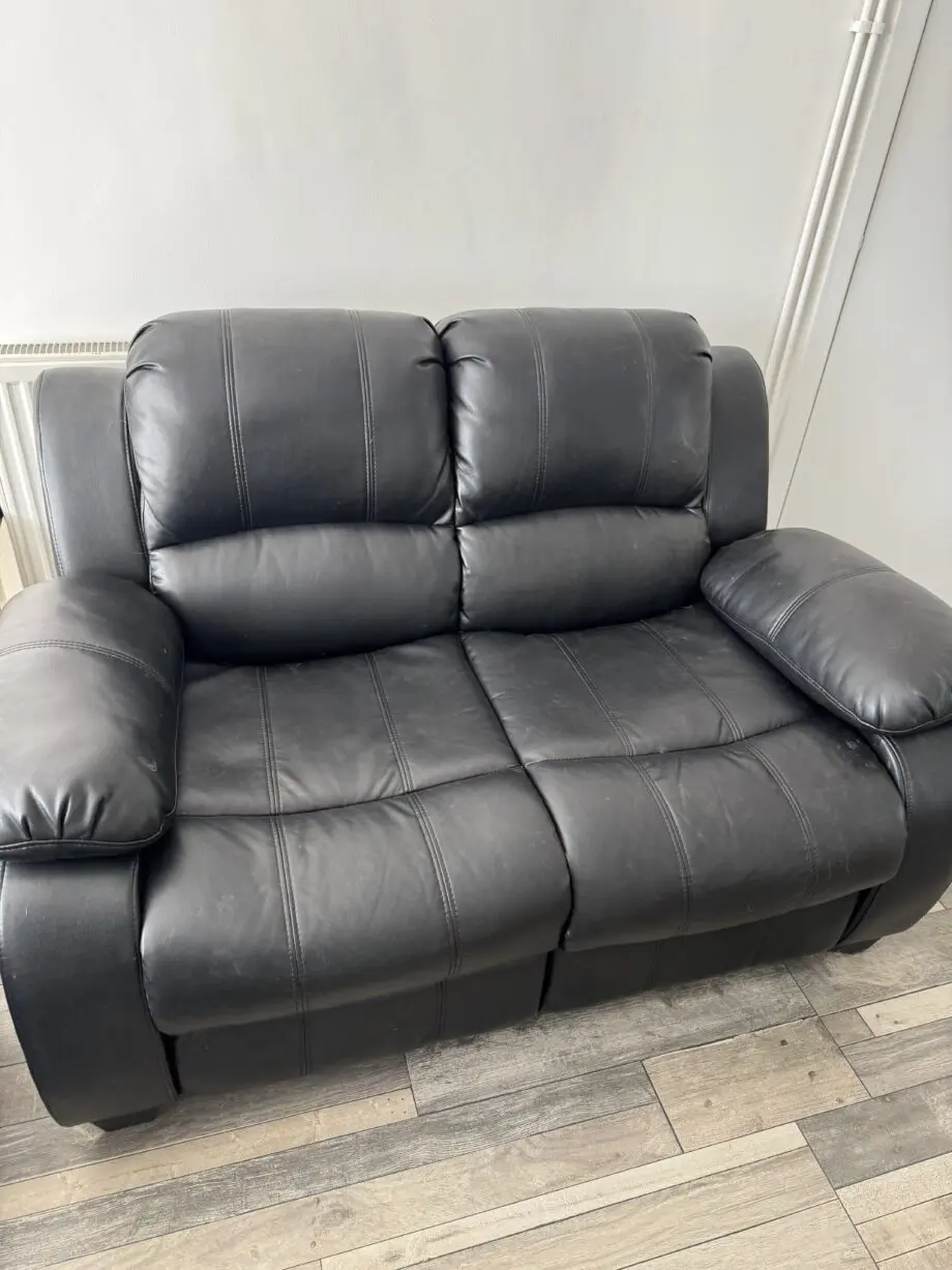 Two x 2 seater black leather sofas