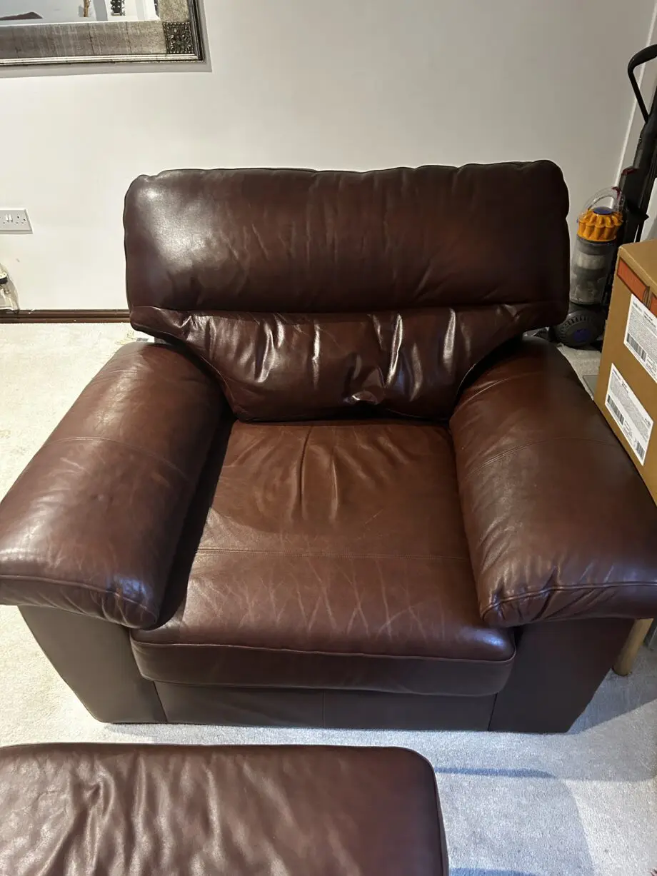 Brown leather 2 seater sofa with matching armchair and storage footstool. Excellent condition