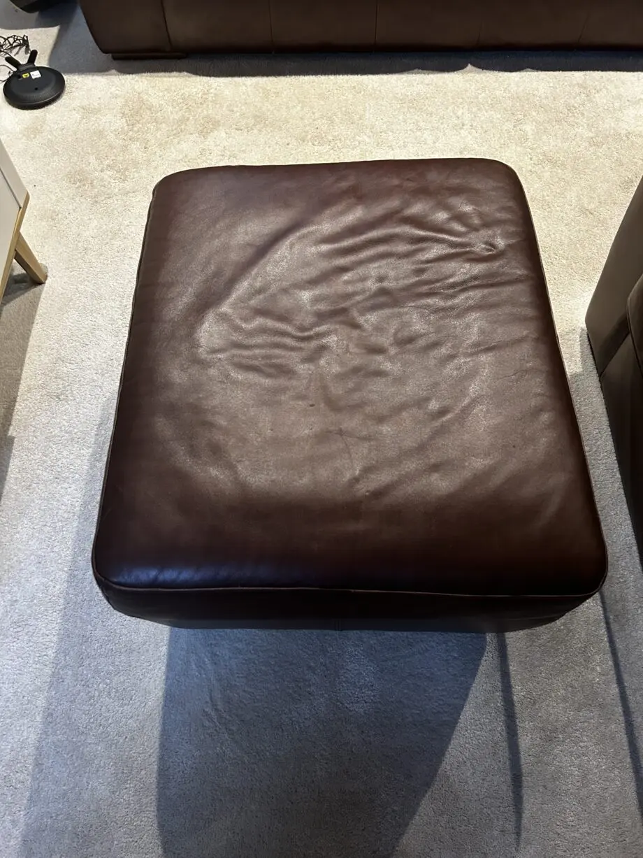 Brown leather 2 seater sofa with matching armchair and storage footstool. Excellent condition