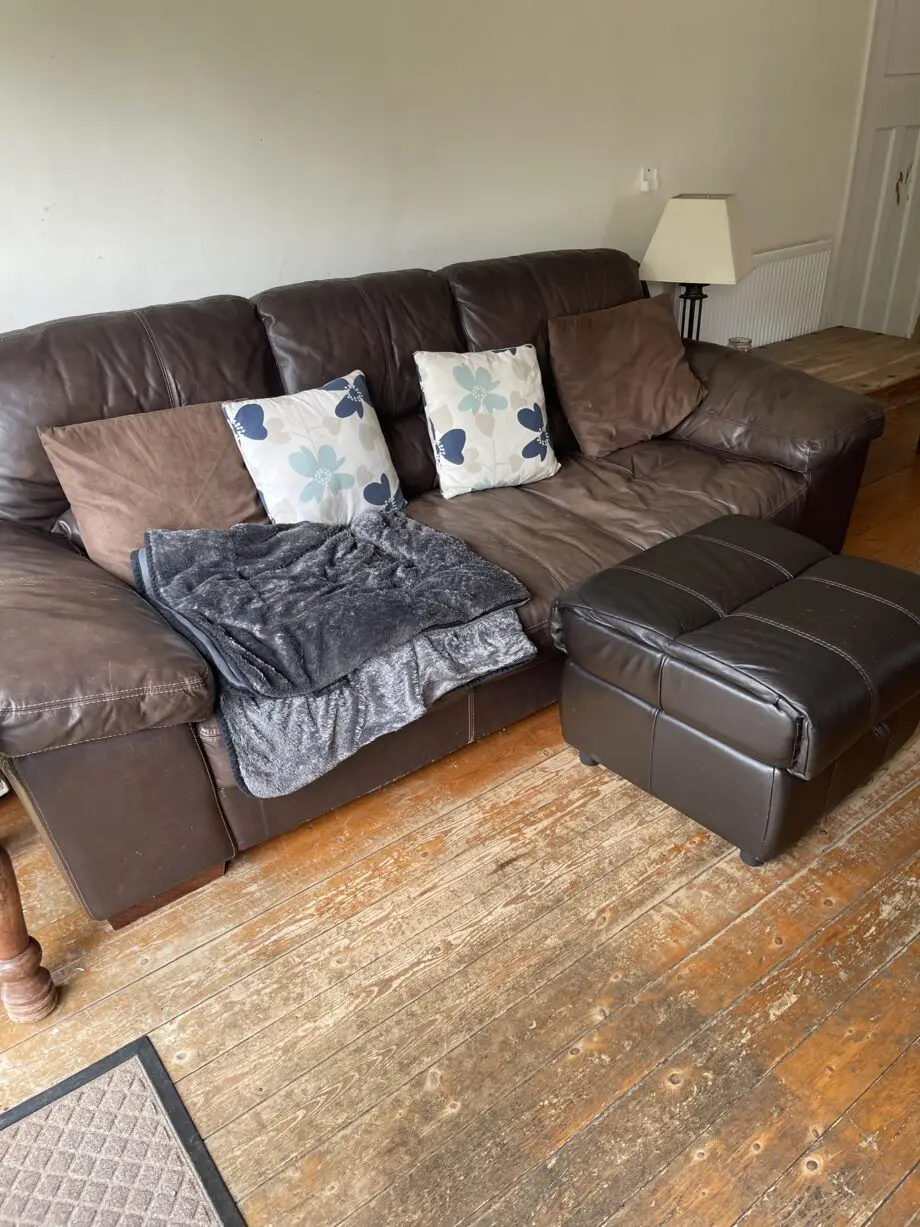 Brown leather sofas and poufees