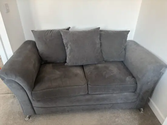 2 x Grey 2 seater scatter back sofas & fooststool