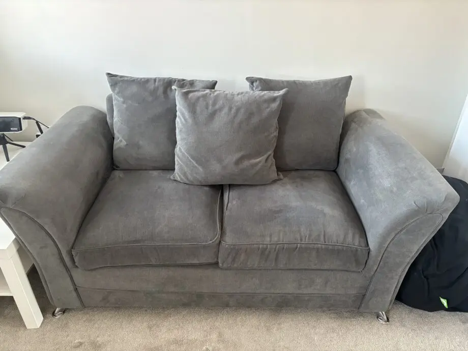 2 x Grey 2 seater scatter back sofas & fooststool