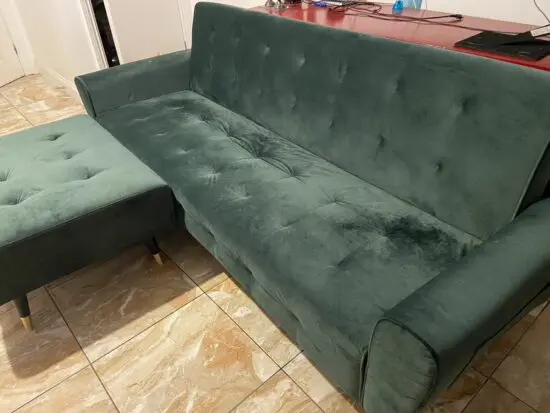 Green velvet sofa bed and stool