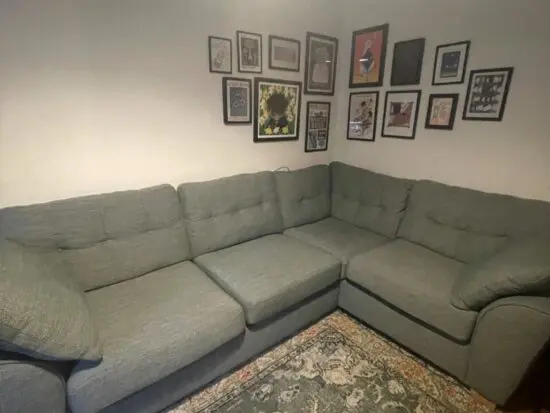 Green fabric corner sofa with pull out mattress