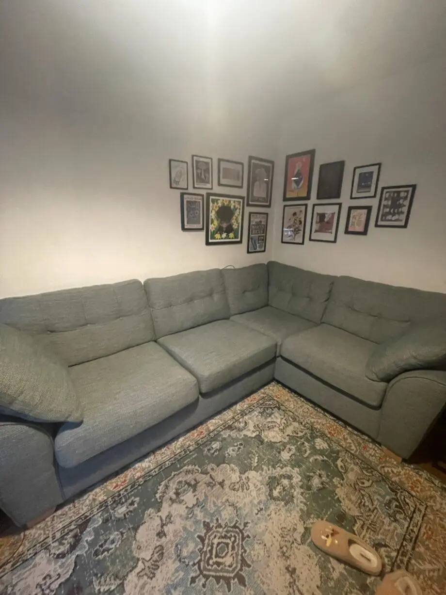 Green fabric corner sofa with pull out mattress