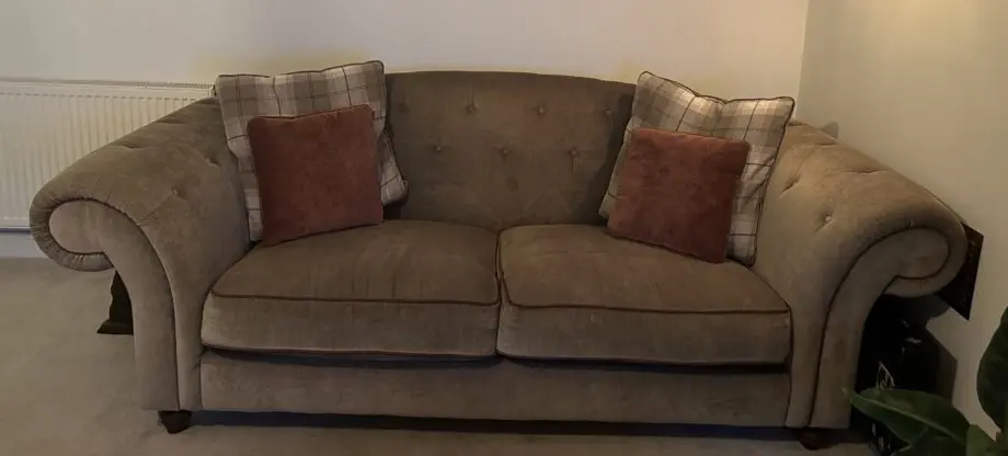 Olive green sofas with coordinating cushions