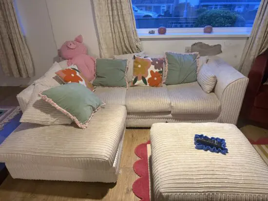 Cream corner sofa with matching footstool
