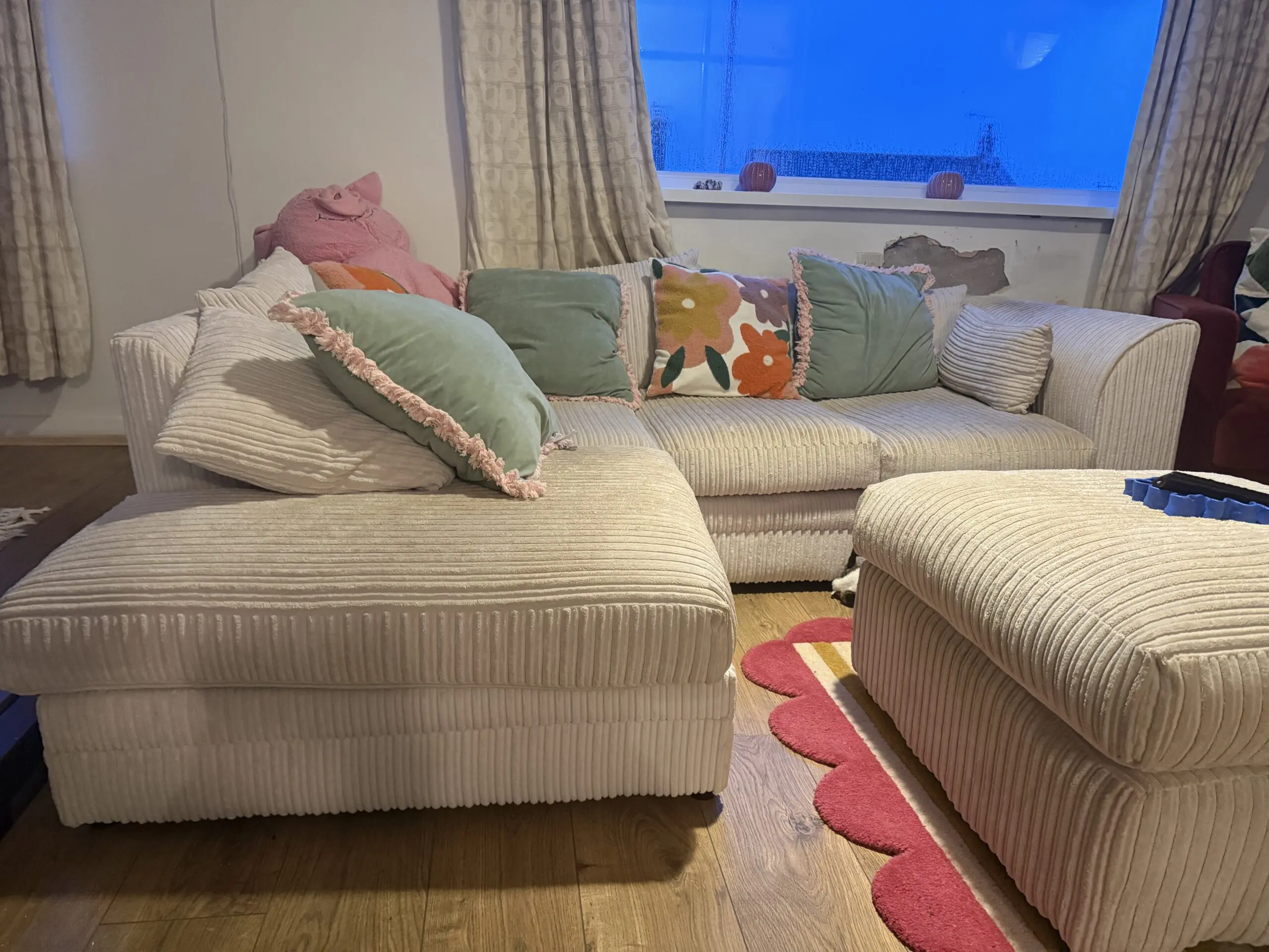 Cream corner sofa with matching footstool
