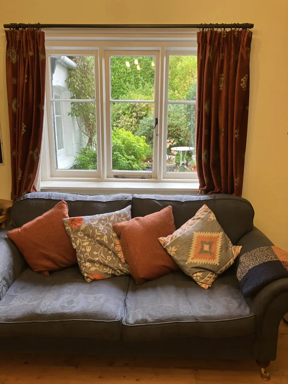 Blue sofa. Extra cushions not included.
