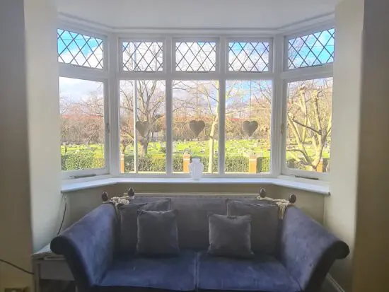 Knole dark blue velvet sofa with adjustable arms tied with tassels