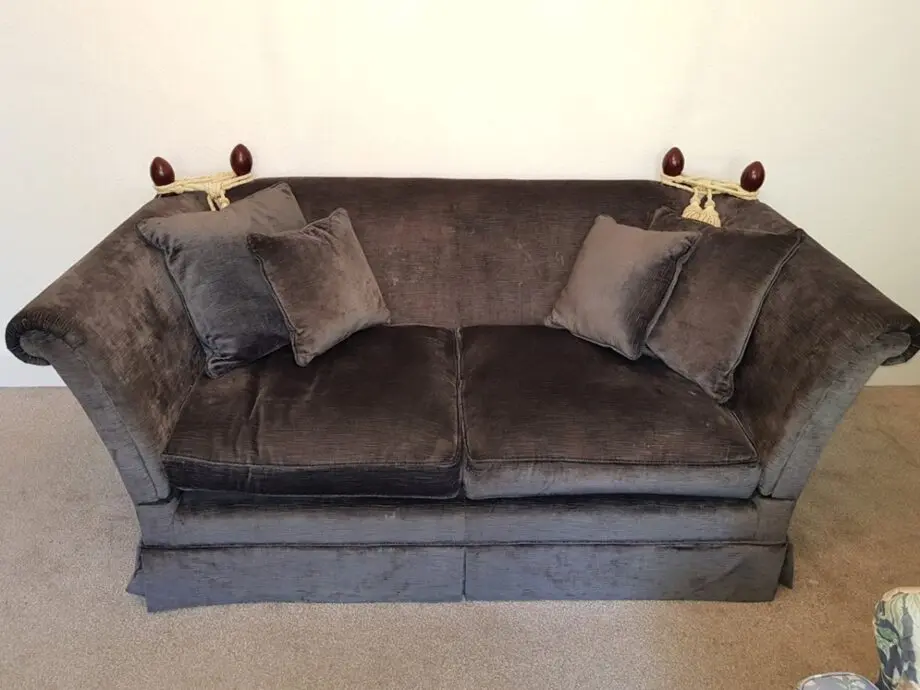 Knole dark blue velvet sofa with adjustable arms tied with tassels
