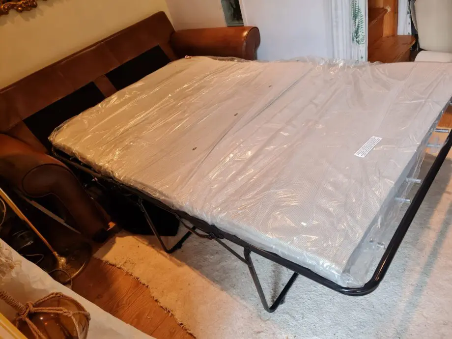 Brown leather 2 seater sofa bed
