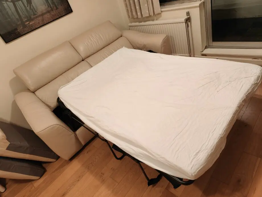 Good quality two seater creme leather sofabed