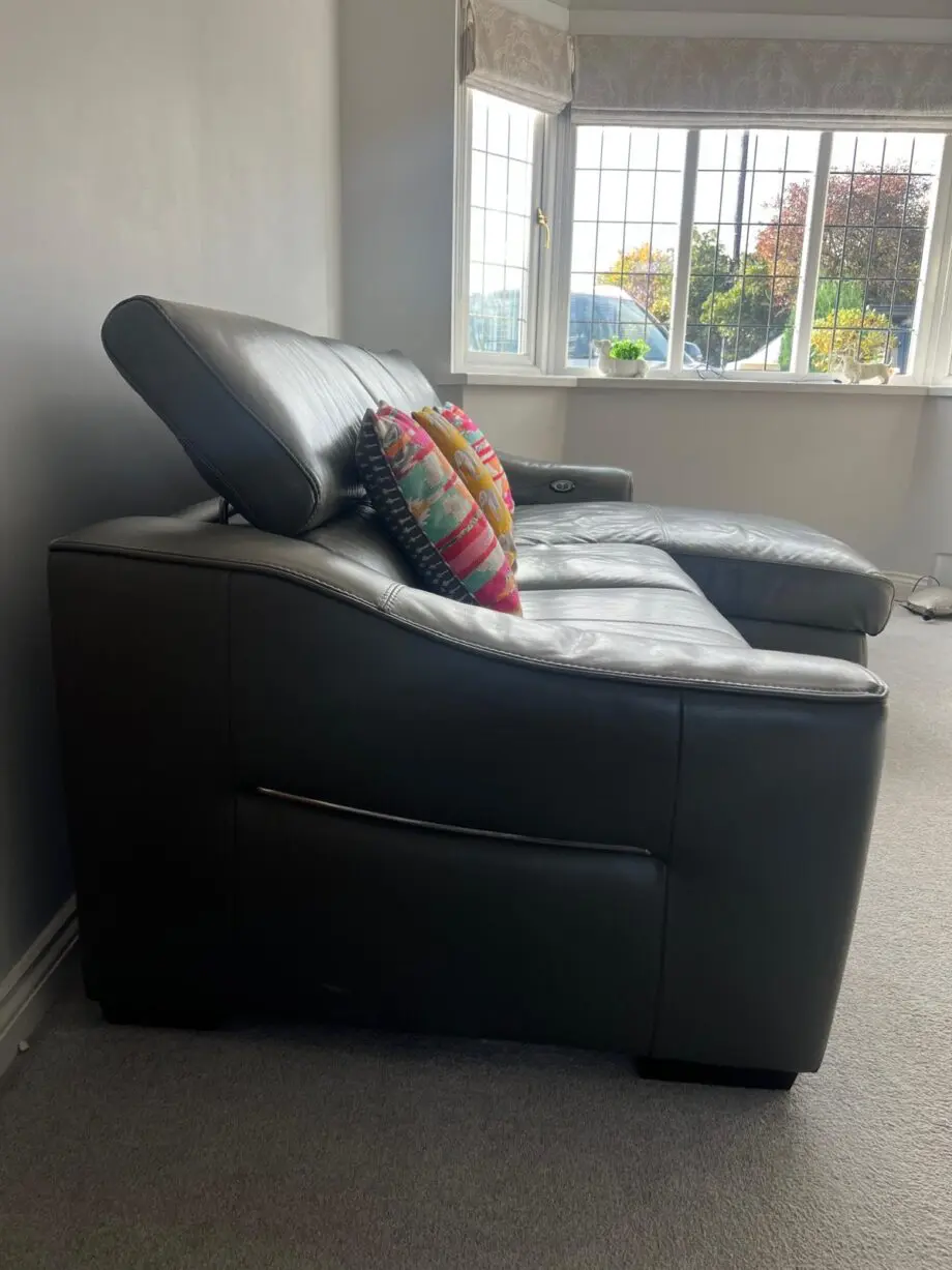 Furniture village, leather sofa with power recliner