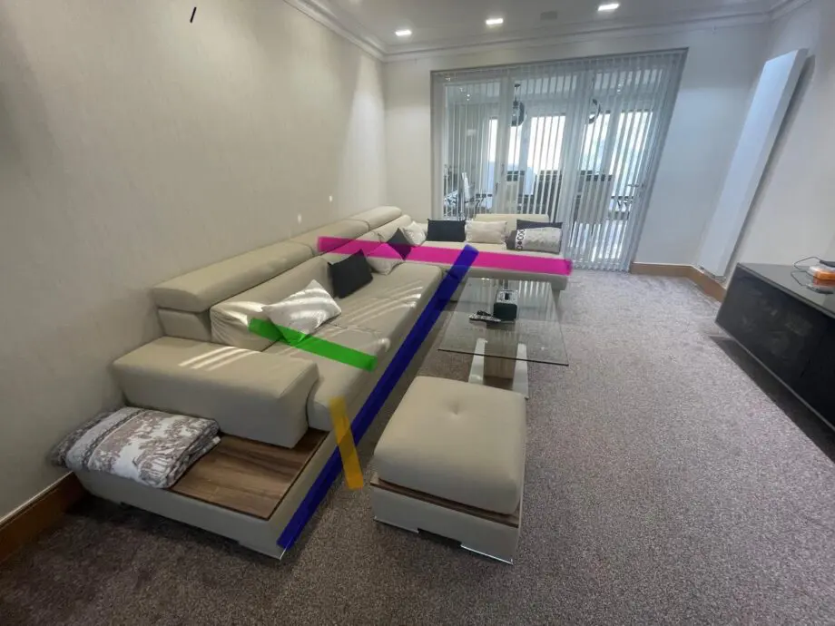 Modern beige/cream leather corner sofa with matching ottoman/footstool.