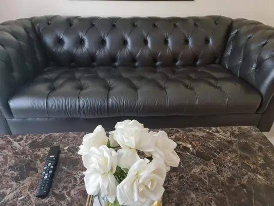 Fully button brown leather sofa