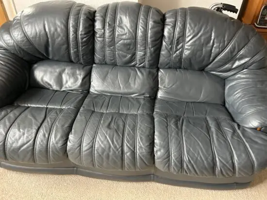 Three piece sweet from furniture village dark blue leather one chair is a swivel and decliner