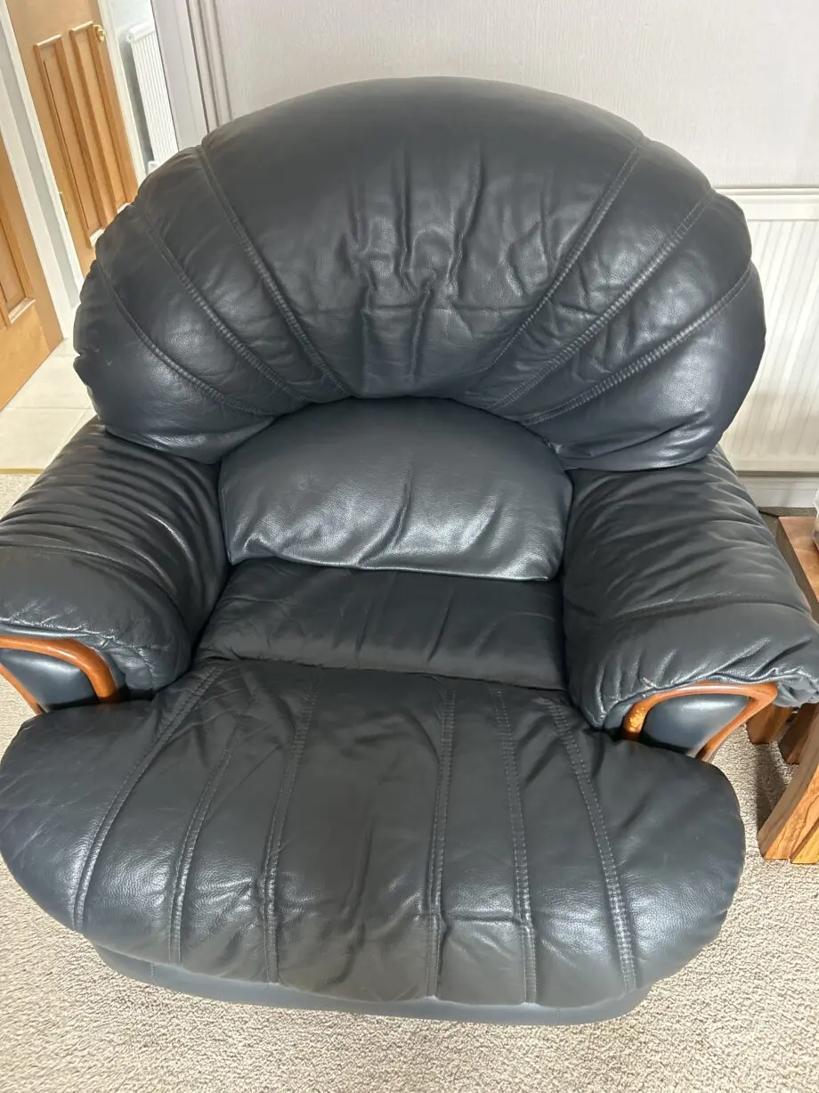 Three piece sweet from furniture village dark blue leather one chair is a swivel and decliner
