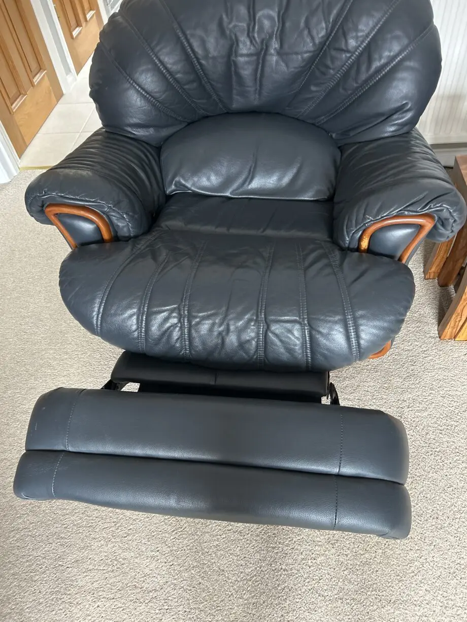Three piece sweet from furniture village dark blue leather one chair is a swivel and decliner