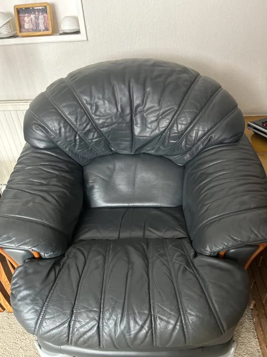 Three piece sweet from furniture village dark blue leather one chair is a swivel and decliner