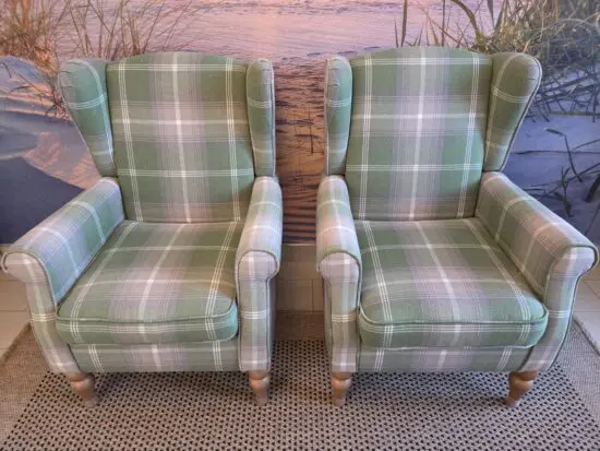 Dunelm Oswald Check Wingback Armchair in a green plaid (sage) fabric.