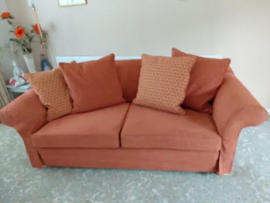 Tetrad reupholstered sofa and chair in burnt orange colour