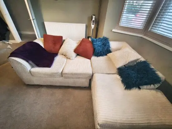 Jumbo cord L shape cream sofa