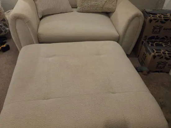 White sofa with large footstall