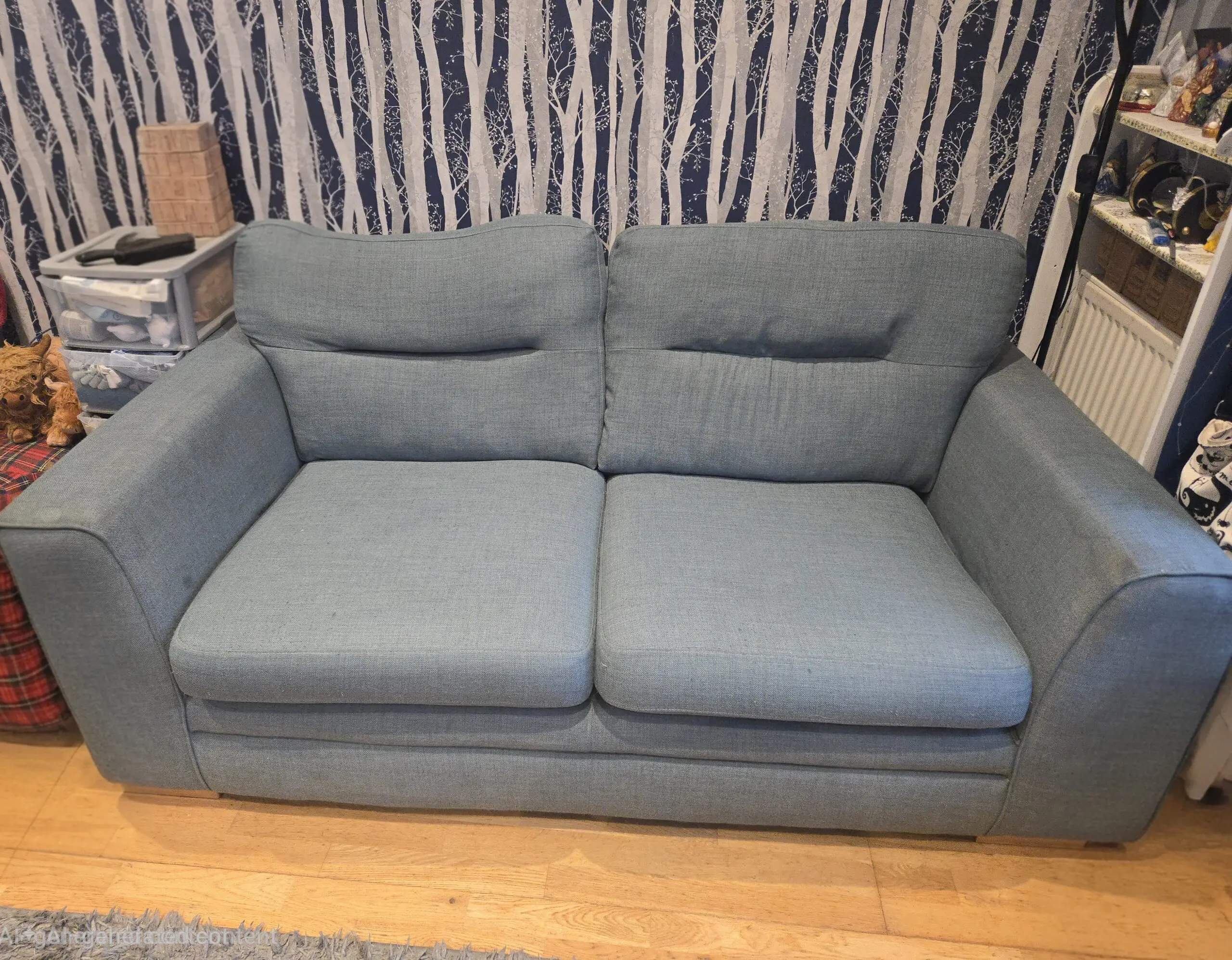 large 3 and 2 seater sofas in a light teal/blue colour