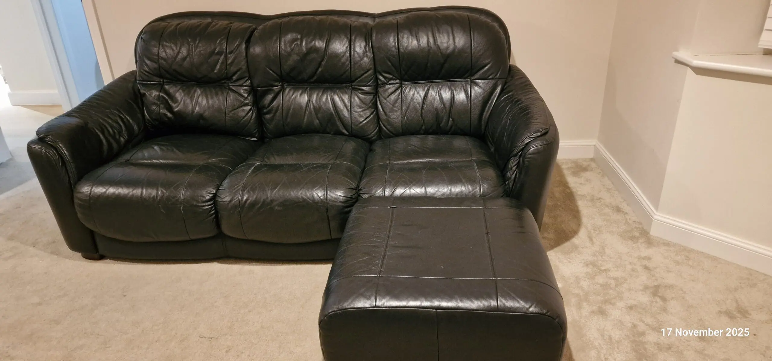 Genuine leather, 4 seater black sofa with pouffe