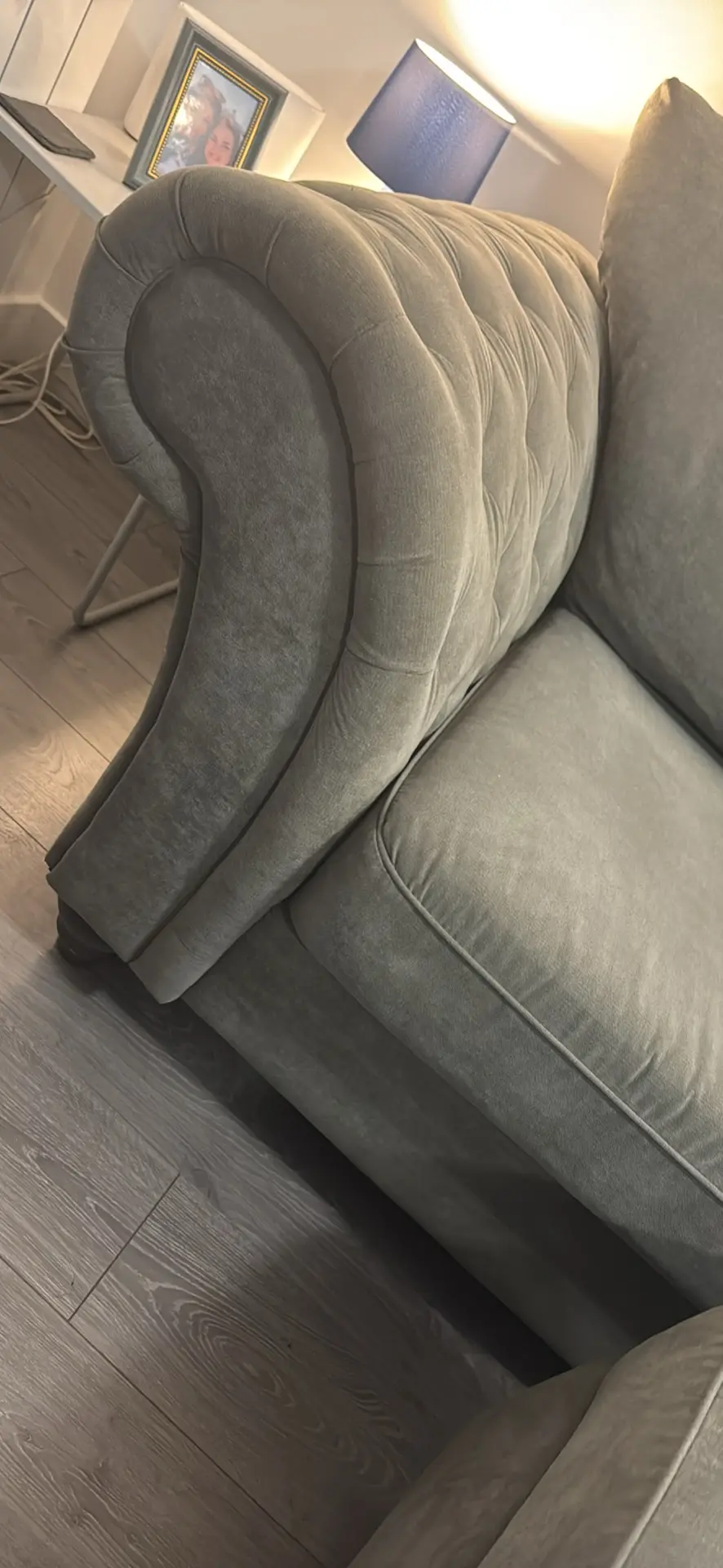 Large grey 4 seater tufted sofa and foot stool