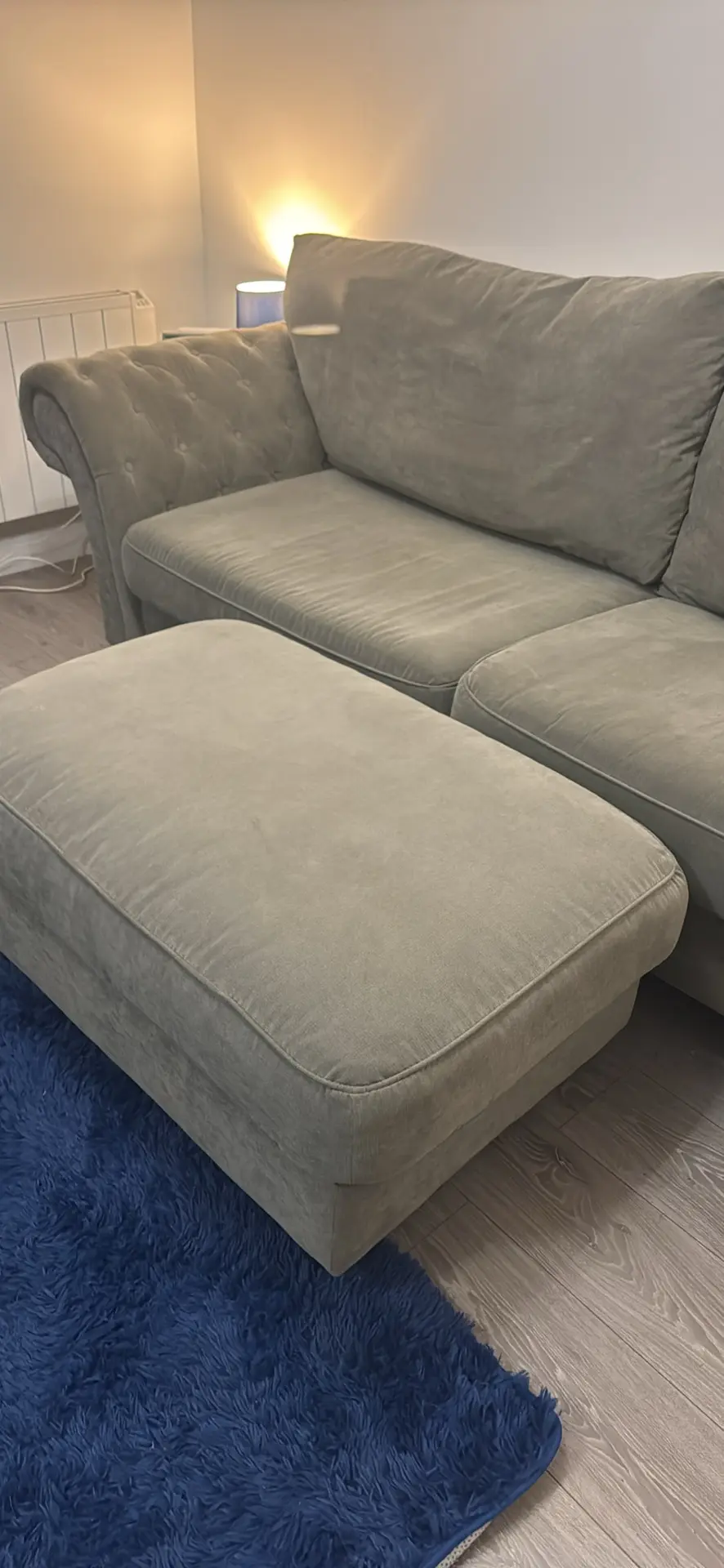 Large grey 4 seater tufted sofa and foot stool