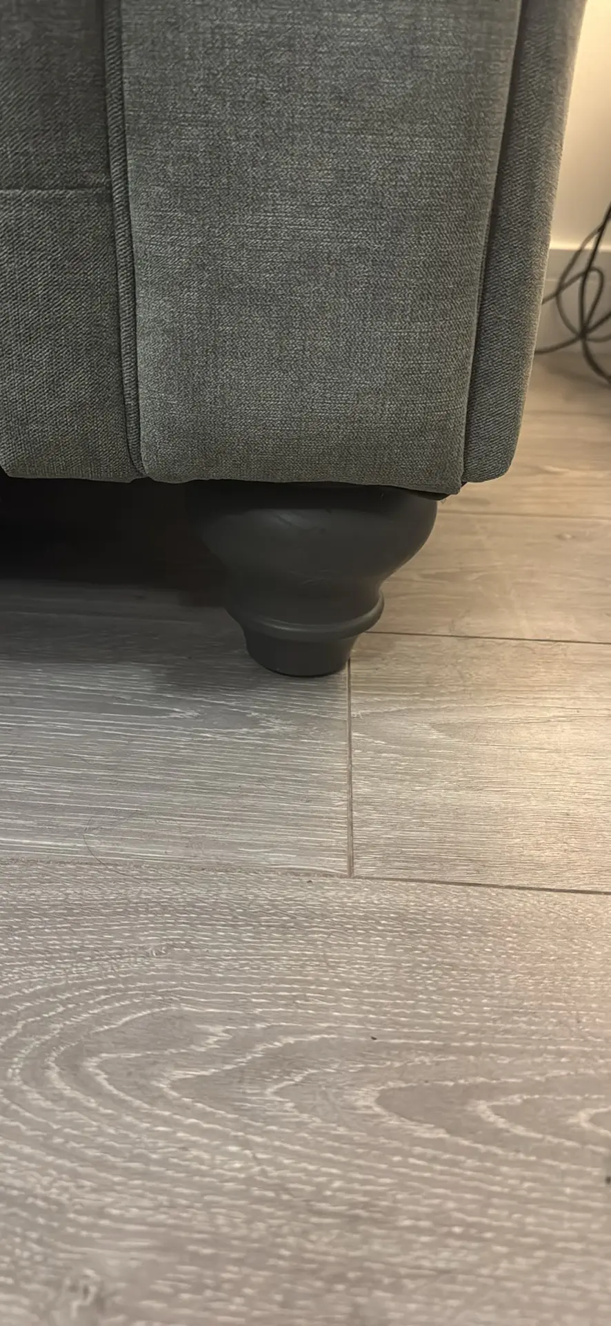 Large grey 4 seater tufted sofa and foot stool