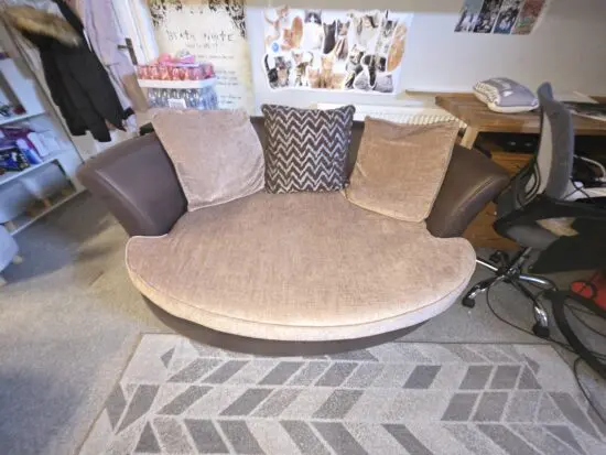 Brown oval 2 seater with 3 pillows