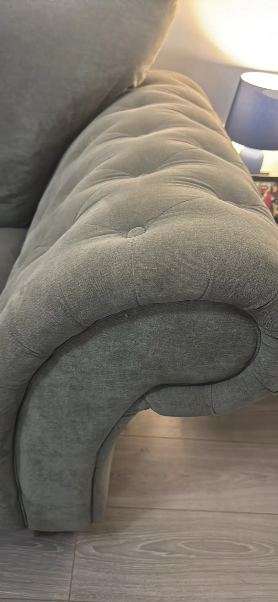 Large grey 4 seater tufted sofa and foot stool