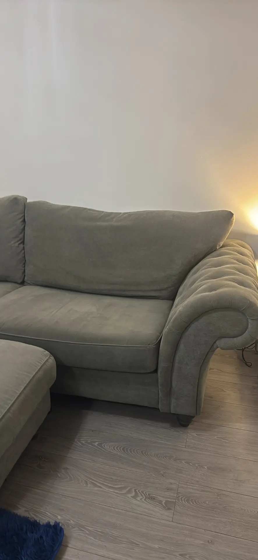 Large grey 4 seater tufted sofa and foot stool